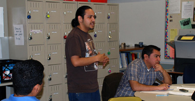 man talking with lockers in background