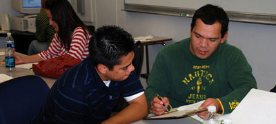 two men working on papers